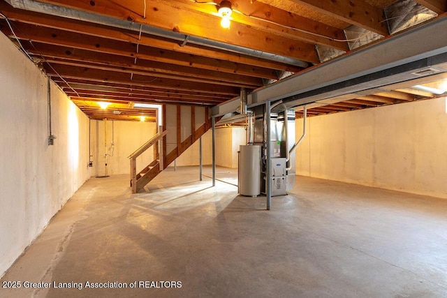 unfinished below grade area with stairs and gas water heater