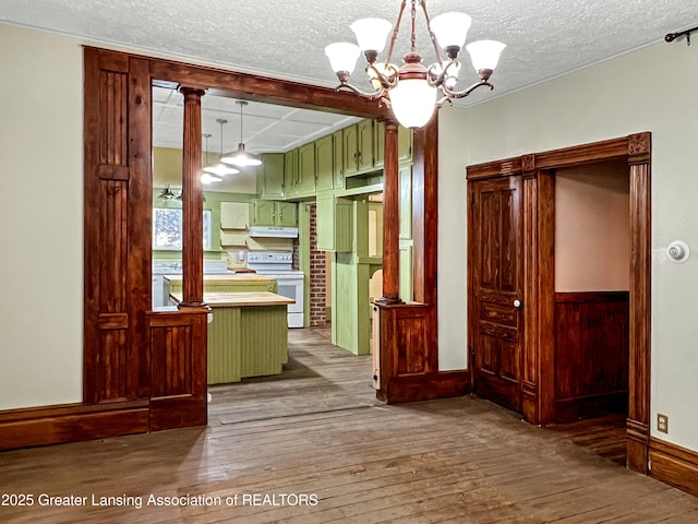 interior space with a chandelier, wood-type flooring, and a textured ceiling