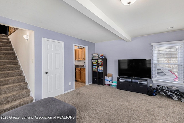 living area with light carpet, baseboards, stairway, and beamed ceiling