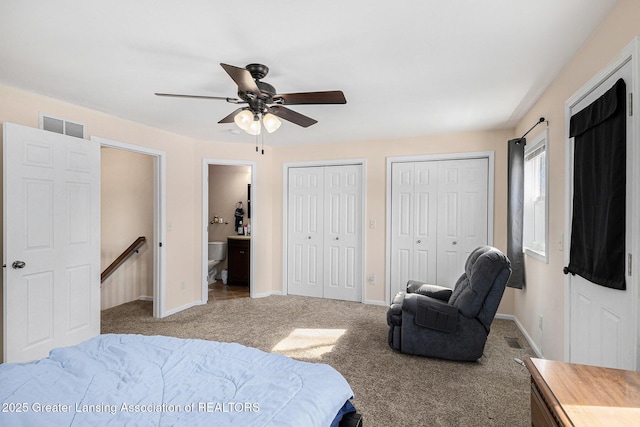 bedroom with multiple closets, visible vents, light carpet, connected bathroom, and baseboards