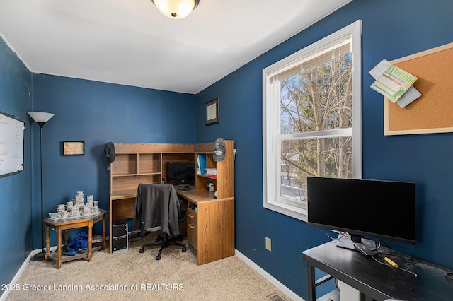 home office with light colored carpet, visible vents, and baseboards