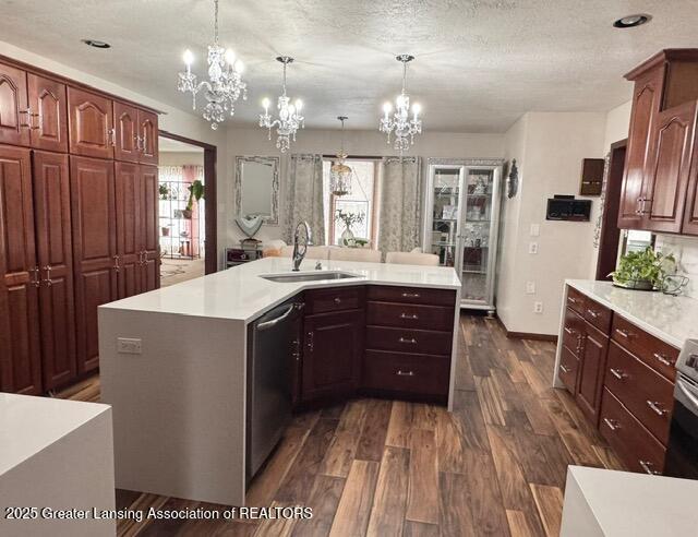 kitchen with dark wood-style floors, plenty of natural light, appliances with stainless steel finishes, and a sink