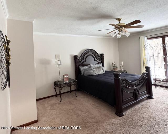 bedroom featuring a textured ceiling, a ceiling fan, baseboards, carpet, and crown molding