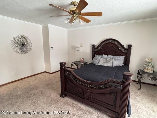 bedroom featuring baseboards, ornamental molding, a textured ceiling, and light colored carpet