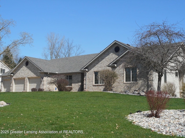 ranch-style house with a garage, a front yard, and brick siding