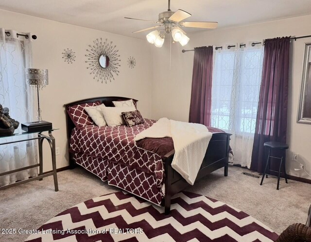 bedroom featuring carpet floors, visible vents, baseboards, and a ceiling fan