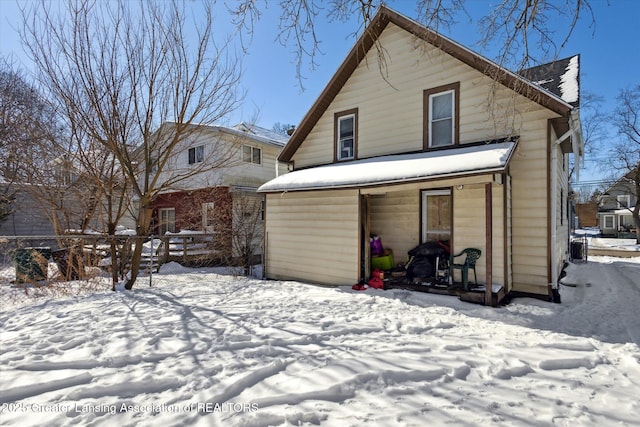 view of snow covered rear of property