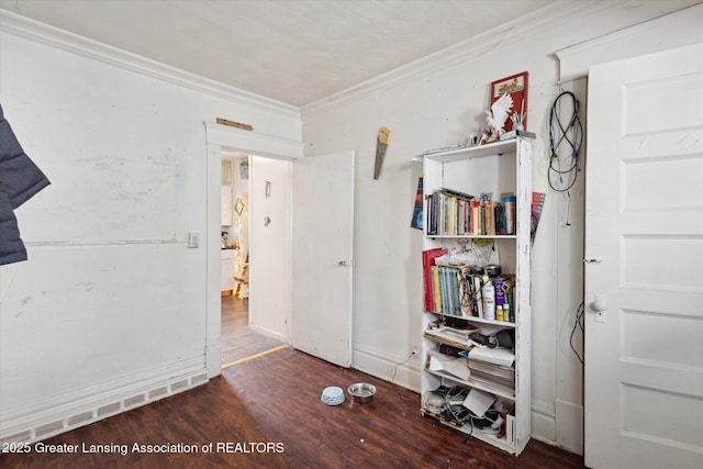 interior space featuring dark wood-style flooring and crown molding