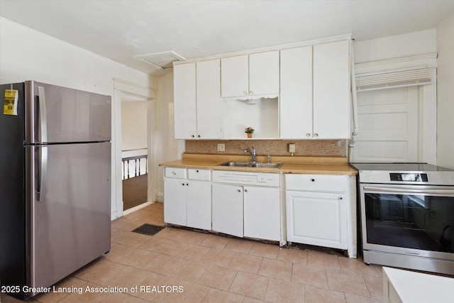 kitchen featuring light countertops, visible vents, appliances with stainless steel finishes, white cabinetry, and a sink