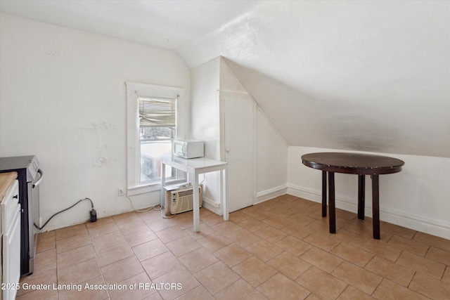 bonus room with vaulted ceiling and light tile patterned flooring