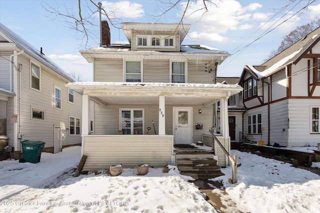 traditional style home with covered porch and a chimney