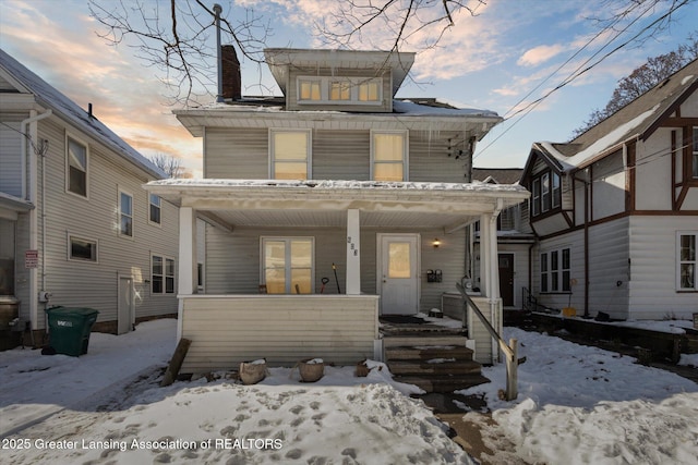 traditional style home featuring covered porch