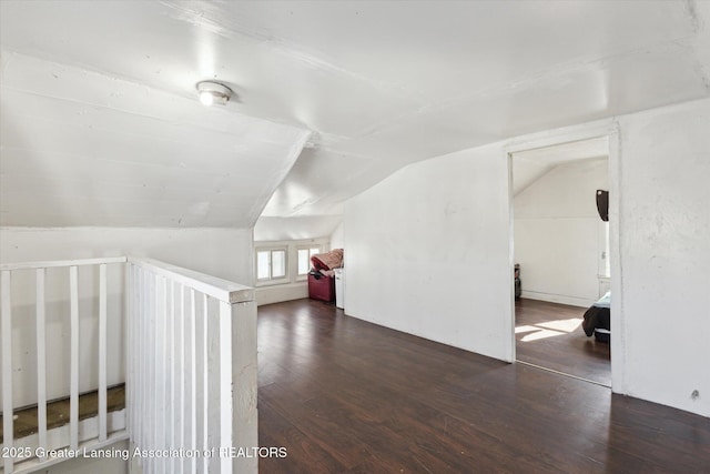 bonus room featuring dark wood-style floors and vaulted ceiling