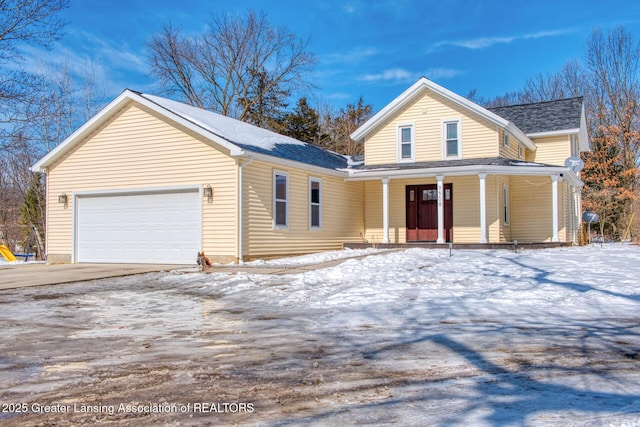 traditional-style house with a garage and covered porch