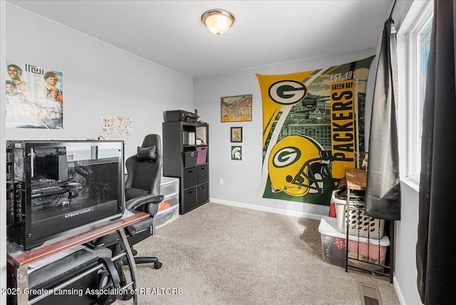 carpeted home office featuring visible vents and baseboards