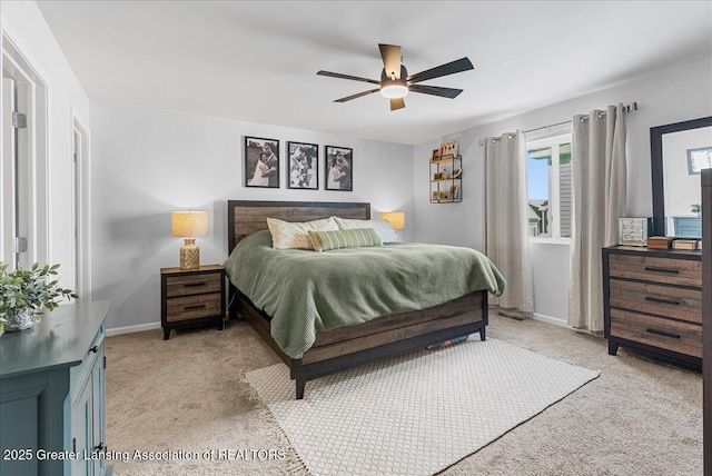 bedroom with baseboards, a ceiling fan, and light colored carpet