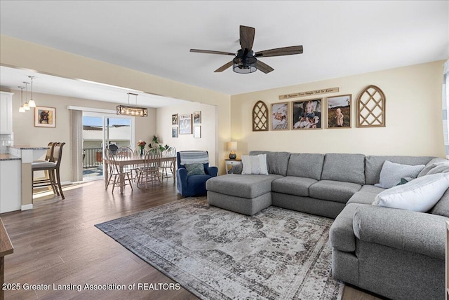 living room featuring a ceiling fan and wood finished floors