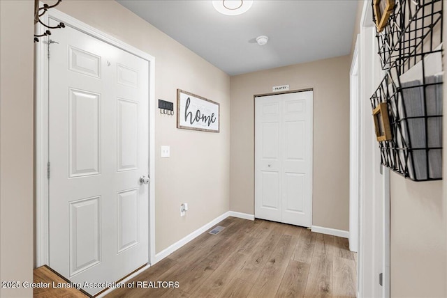 interior space with baseboards and wood finished floors