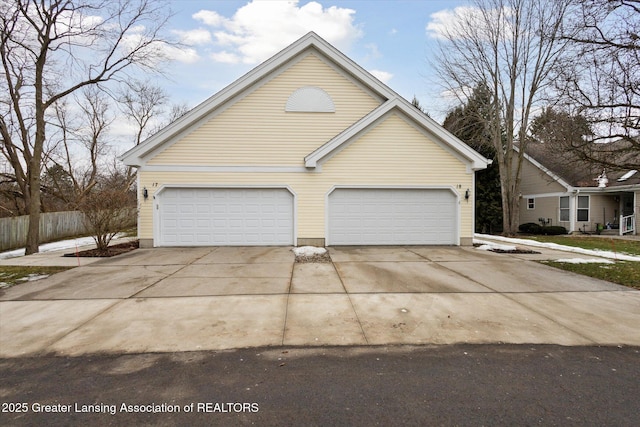 view of home's exterior with a garage and driveway