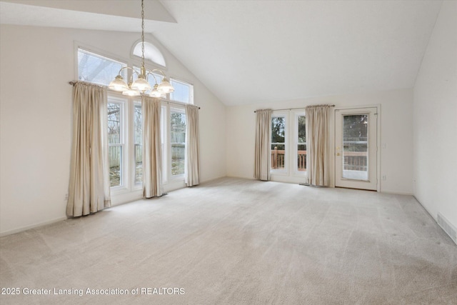 unfurnished room with light carpet, high vaulted ceiling, and a notable chandelier