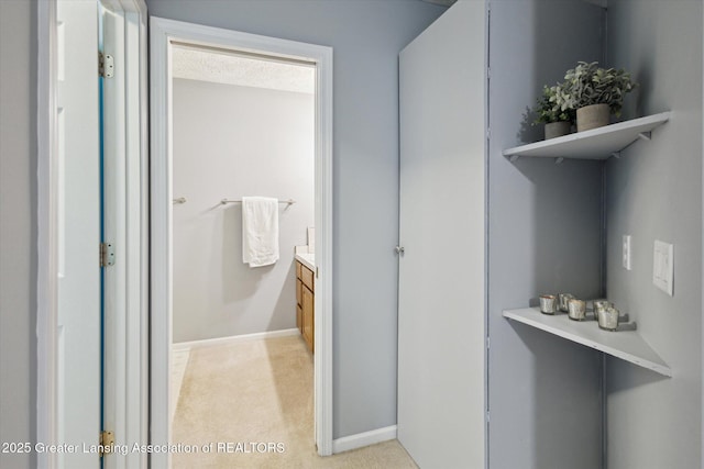 bathroom featuring baseboards and vanity