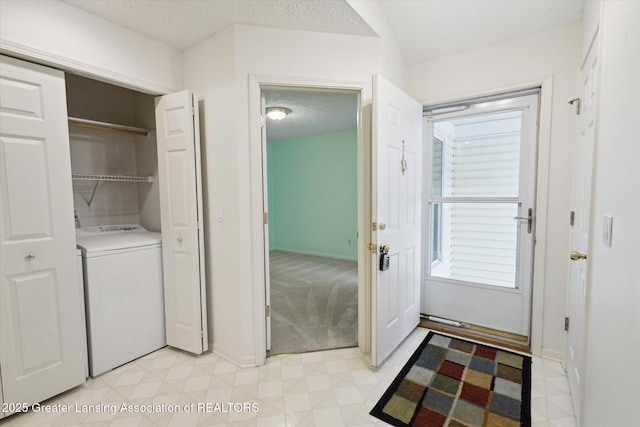 laundry area with a textured ceiling, laundry area, washer / clothes dryer, and baseboards