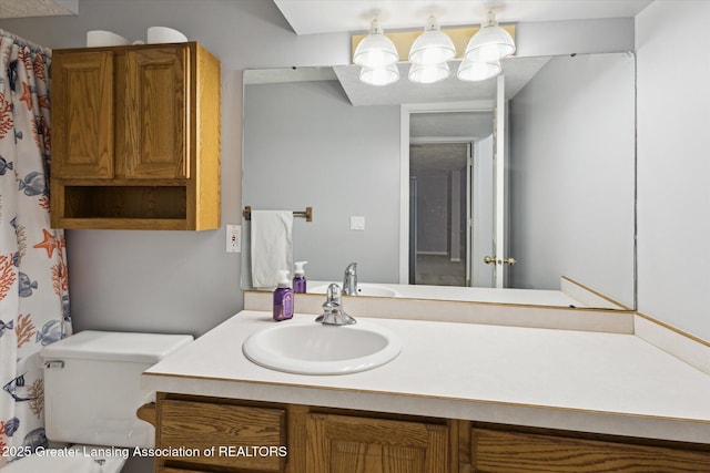 full bathroom with toilet and vanity