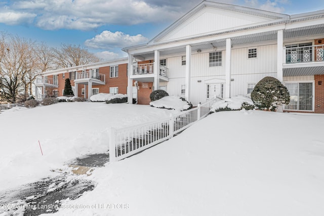 view of snow covered back of property