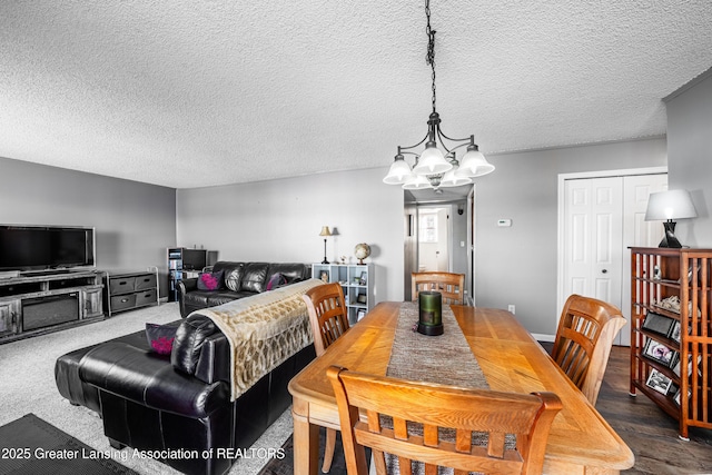 dining room featuring a textured ceiling and a notable chandelier