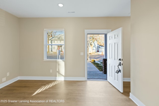 entryway featuring recessed lighting, wood finished floors, visible vents, and baseboards