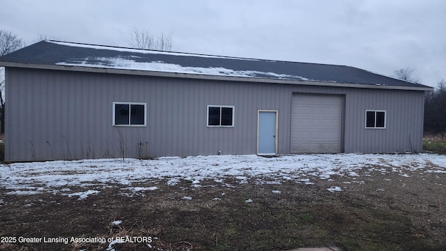 snow covered structure featuring an outbuilding