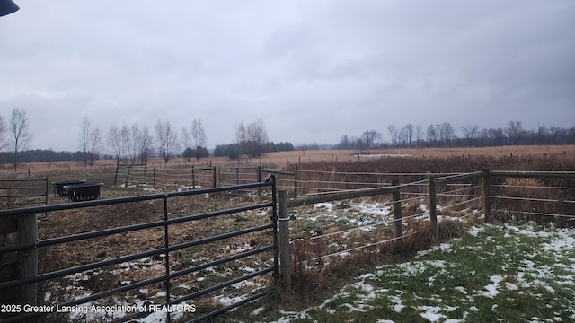 view of yard featuring fence and a rural view