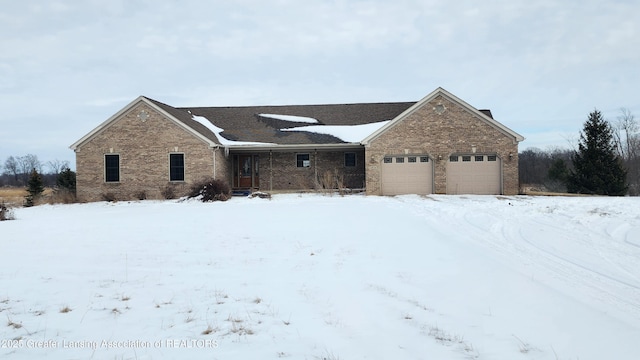 ranch-style home with a garage and brick siding