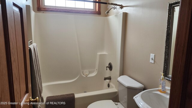 full bathroom featuring tub / shower combination and toilet