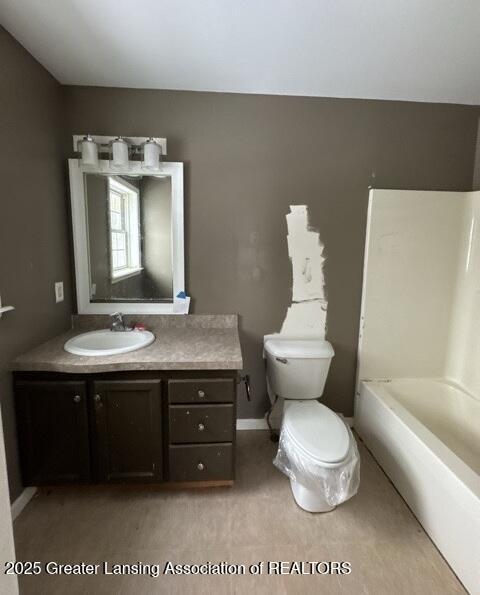 bathroom with baseboards, vanity, and toilet