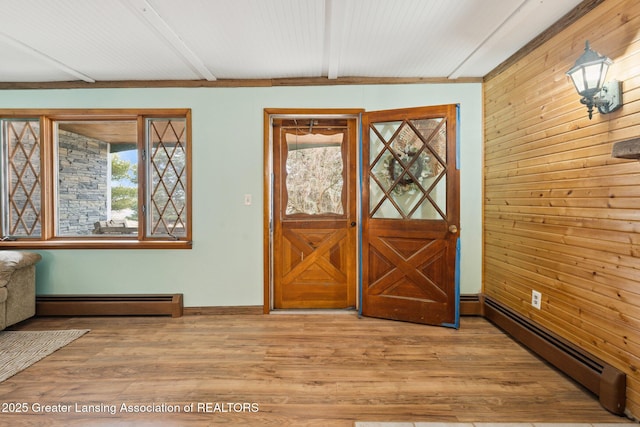 foyer featuring light wood-style floors, baseboard heating, and beam ceiling