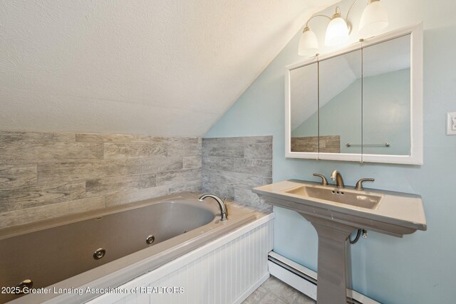 bathroom featuring a baseboard heating unit, a textured ceiling, a whirlpool tub, and lofted ceiling