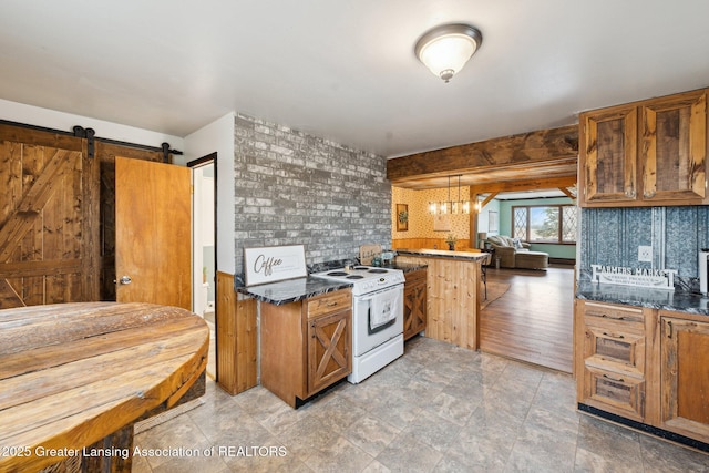 kitchen featuring white electric stove, a barn door, a notable chandelier, brown cabinetry, and dark stone countertops