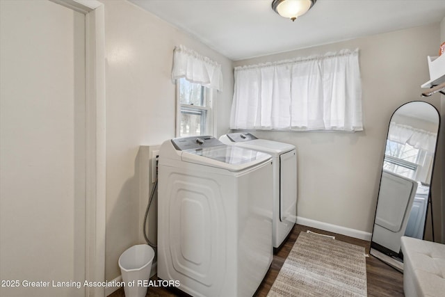 laundry room with dark wood-style floors, laundry area, washer and clothes dryer, and baseboards