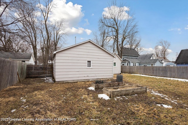 exterior space featuring a garden and a fenced backyard