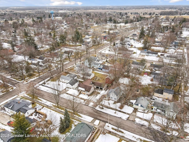 snowy aerial view with a residential view