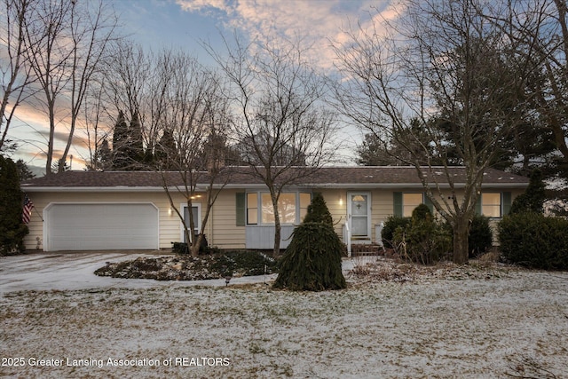 ranch-style house with driveway and an attached garage