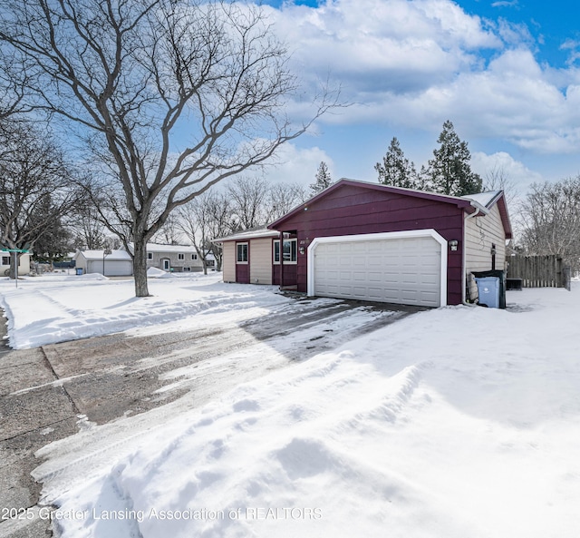 snow covered property with fence