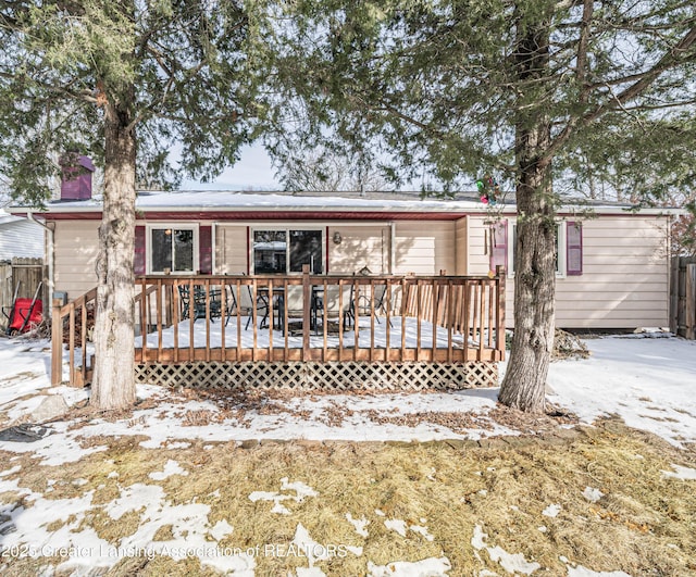 view of front of home featuring fence and a wooden deck