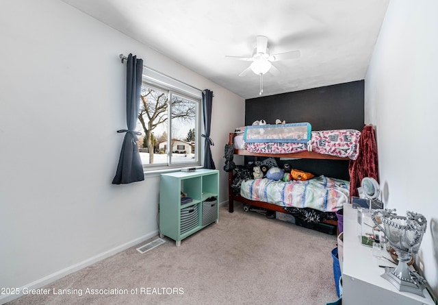 bedroom featuring a ceiling fan, light carpet, visible vents, and baseboards