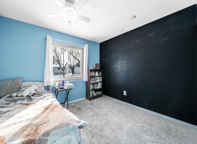 carpeted bedroom with ceiling fan and baseboards