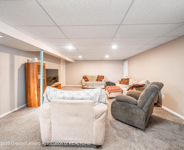 living room featuring carpet floors, baseboards, a drop ceiling, and recessed lighting