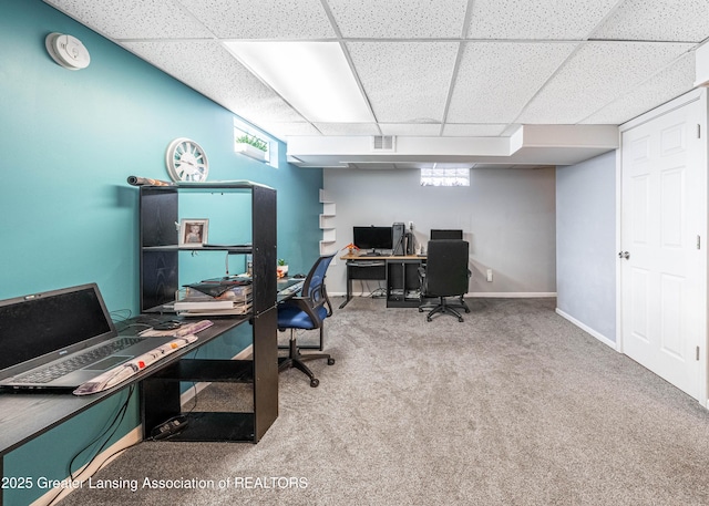 office area with plenty of natural light, baseboards, visible vents, and carpet flooring