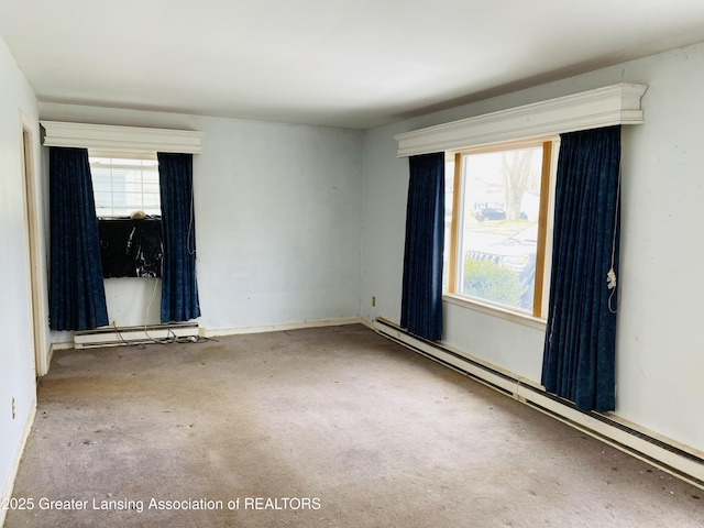 spare room featuring baseboard heating and a wealth of natural light