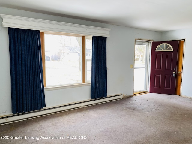 carpeted foyer with baseboard heating